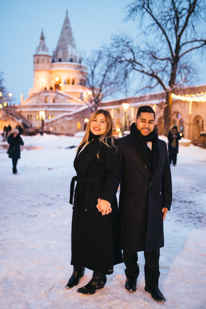 Couple enjoying a Budapest honeymoon at the Fisherman’s Bastion during winter